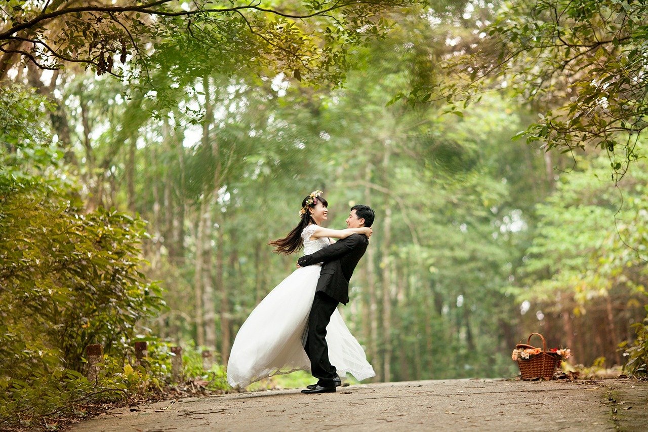 Even if you are planning an impromptu wedding, there are a few things you must do. This is an image of a happy, just married couple at a park.